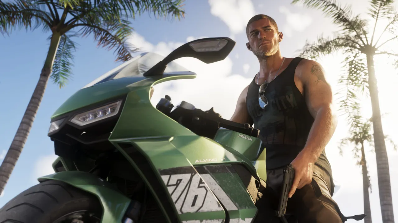 Jason standing beside a green motorcycle on a palm-lined street